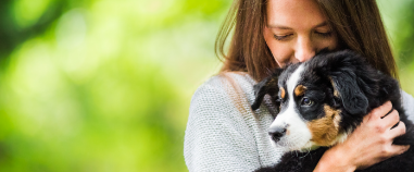 girl holding puppy